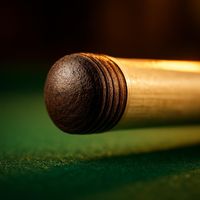 Close-up of a layered leather cue tip on a cue shaft