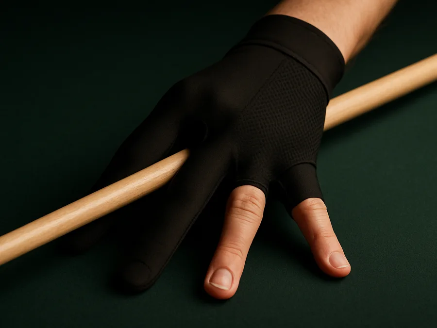 A bridge hand in a black three-finger billiard glove resting on a cue shaft